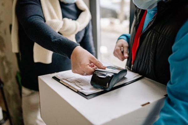 a person using a credit card tap pos system